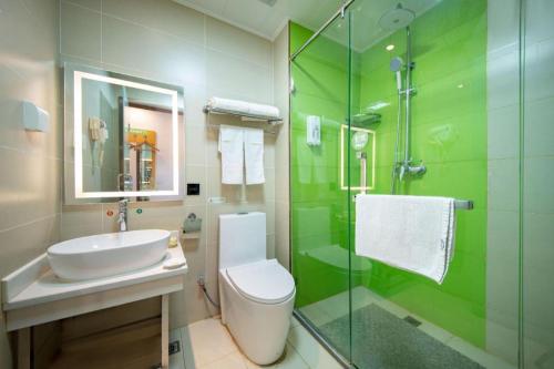 a bathroom with a toilet and a sink and a shower at GreenTree Inn Huayin Huashan Town Huashan Scenicspot Express Hotel in Huayin