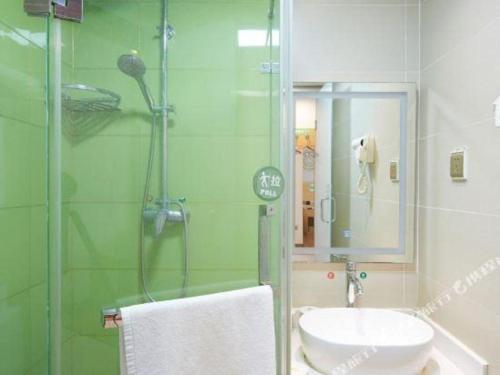 a bathroom with a shower and a toilet and a sink at GreenTree Inn Huayin Huashan Town Huashan Scenicspot Express Hotel in Huayin