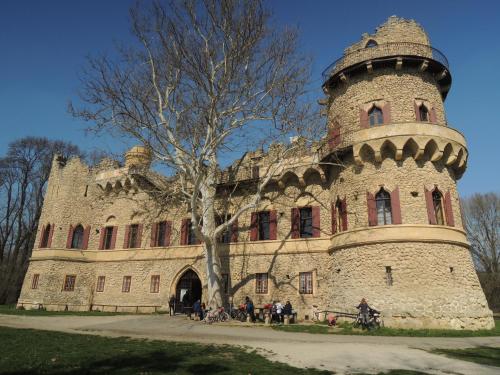 a large stone building with a tree in front of it at Apartmány Hlohovec in Hlohovec