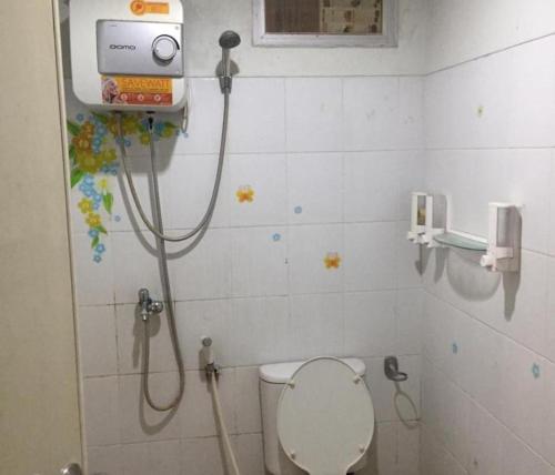 a bathroom with a shower with a toilet in it at OYO Living 3091 Apt The Suites Metro By Ananda in Bandung