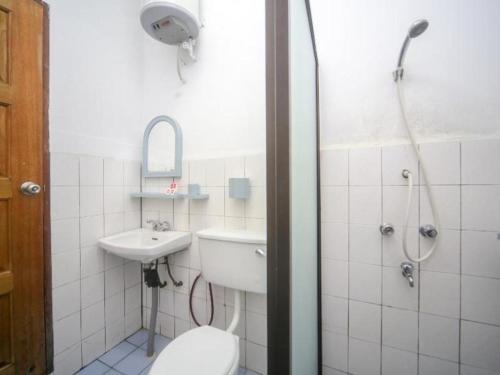 une salle de bain avec toilettes, lavabo et douche dans l'établissement OYO 89537 Fairy Garden Resort, à Kampong Kinasaraban