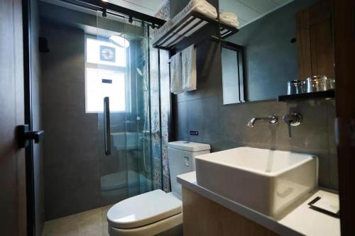 a bathroom with a sink and a toilet and a shower at London Hotel in Macau
