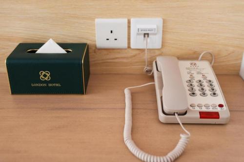 a telephone and a box on a table at London Hotel in Macau