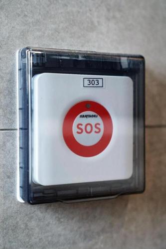 a box with a sign that says sos at London Hotel in Macau
