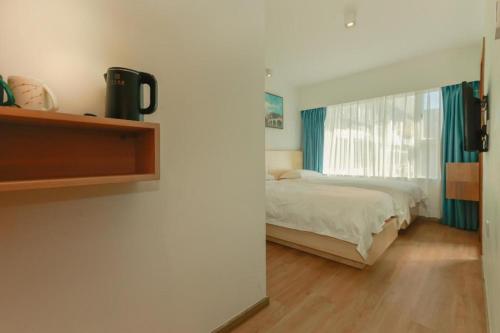 a bedroom with a bed and a window at London Hotel in Macau