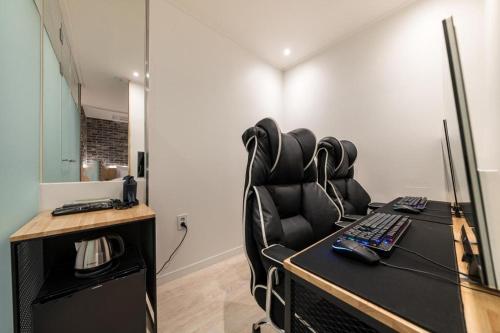 an office with a desk with a chair and a keyboard at Crossing Hotel in Seoul