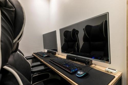 a desk with a computer monitor and a keyboard and mouse at Crossing Hotel in Seoul