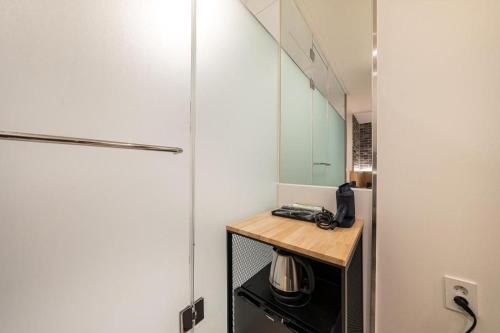 a small kitchen with a counter and a microwave at Crossing Hotel in Seoul