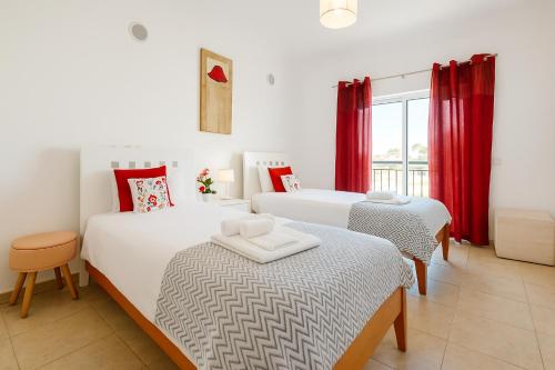 a hotel room with two beds and a window at Spacious Apartment with Huge Terrace and Swimming Pool in Lagos