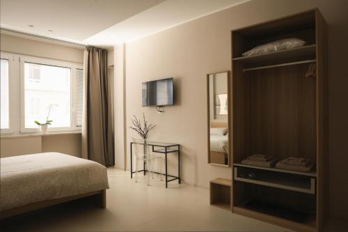 a bedroom with a bed and a mirror and a tv at B&B Il Rifugio Urbano in Pescara