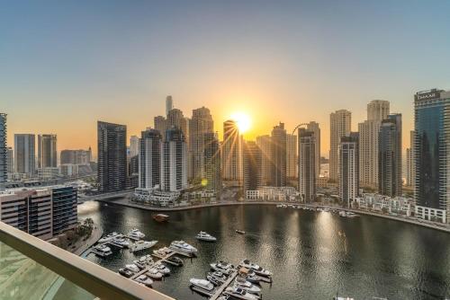 a view of a city with boats in a harbor at Panoramic Marina 1BR City Skyline Views with Balcony, Pool & Gym Access in Dubai