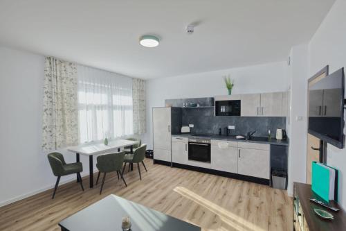 a kitchen and dining room with a table and chairs at Ferienquartier Forsthaus 2 in Bad Gottleuba