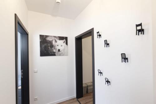 a hallway with two mirrors and a dog on the wall at Ferienquartier Forsthaus 2 in Bad Gottleuba