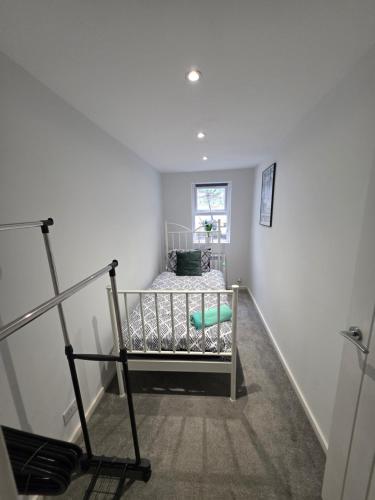 a bedroom with a bed in the corner of a room at Tranquil & Subtle - 8ight Havens Folkestone in Folkestone