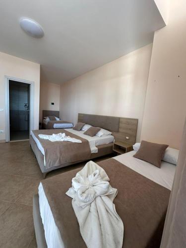 a hotel room with two beds in a room at LA PLAYA - Seaside Guest Room in Durrës