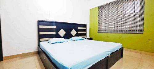 a bedroom with a large bed in a room at Elite Residency in Taliparamba