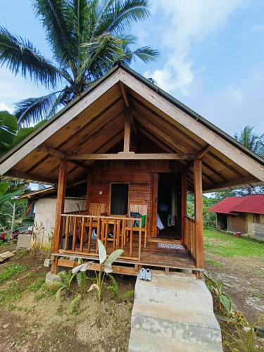 a small wooden house with a porch at Dewi Rinjani Homestay in Tetebatu