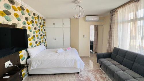 a living room with a bed and a couch at The oceanic 48 in Durban