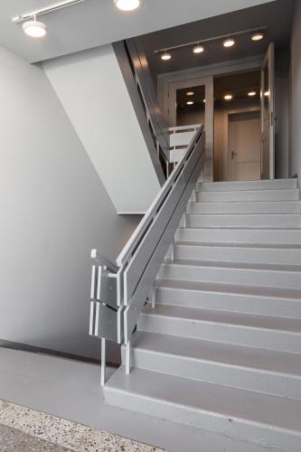 a set of stairs in a building with a stair case at Roze Park Rooms in Liepāja