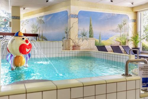 a pool in a hotel with a water fountain at Englmar Apartments with free WELLNESS and FITNESS in Sankt Englmar
