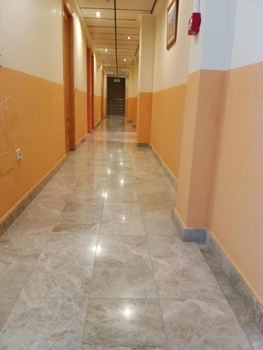 an empty hallway with a tile floor in a building at Hostal Casa Pancho in Sangonera La Seca