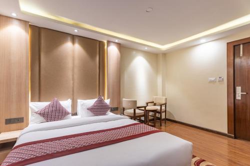 a hotel room with a large bed with purple pillows at Amarawati Boutique Hotel in Kathmandu