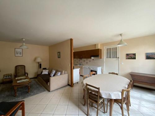 a living room with a table and a couch at La Maison de Claire in Flavigny-sur-Ozerain