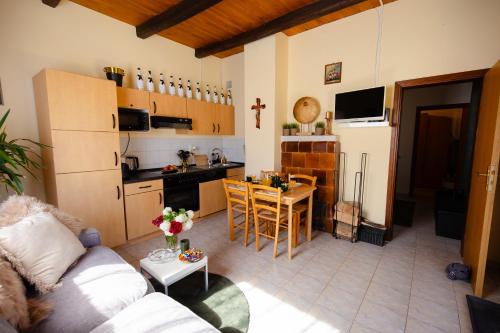 a living room and kitchen with a couch and a table at Kuća za odmor Mia 