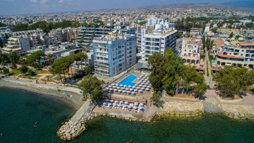 an aerial view of a city with a beach and buildings at Harmony Bay Hotel in Limassol