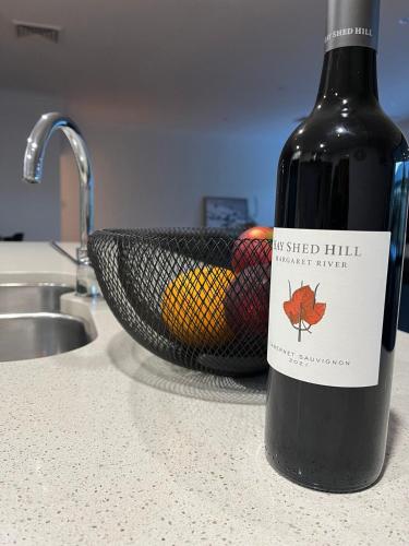 a bottle of wine sitting on a counter next to a sink at Royal-Tee Retreat in Dunsborough