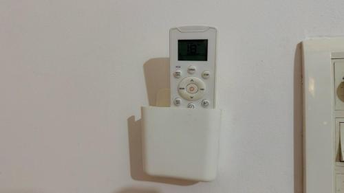 a white remote control is on a wall at Luxury 4BHK Bunglow in Posh Colony in Patna