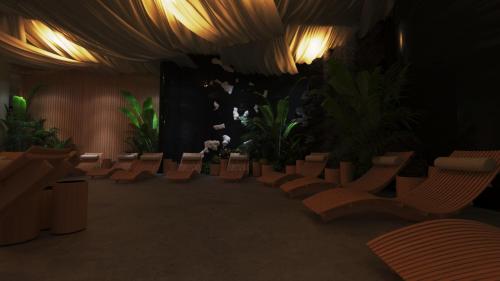 a room with chairs and plants and lights at Royal G Max in Golem