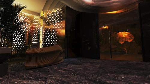 a room with a chair and a wall with lights at Royal G Max in Golem
