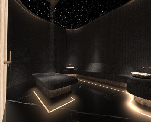 a black room with a stool and a star ceiling at Royal G Max in Golem