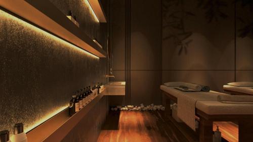 a bathroom with a sink and a counter with bottles at Royal G Max in Golem