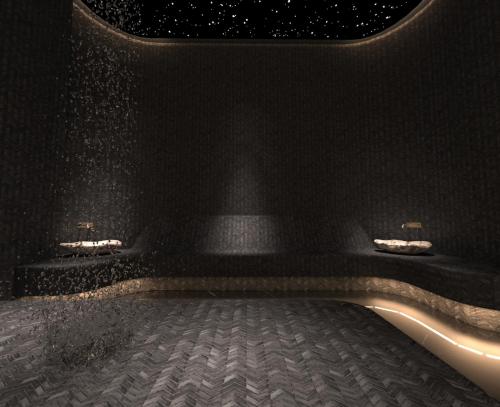 a black wall with two benches in a room at Royal G Max in Golem