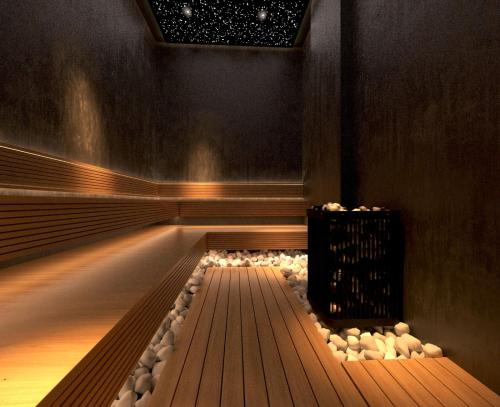 a swimming pool with a bench in a room at Royal G Max in Golem