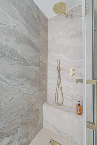 a bathroom with a shower with a shower head at Modern Apartament near city centre in Perth
