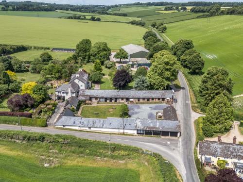 an aerial view of a mansion with a road at The Old Cart Shed in Blandford Forum