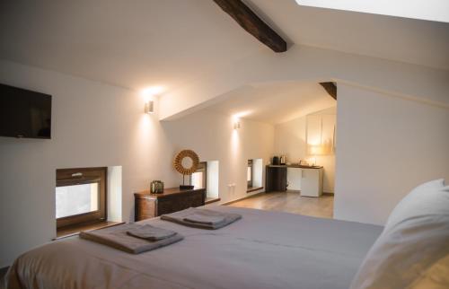 a bedroom with a bed with two towels on it at Dario Coos srl - Azienda vinicola in Sedilis