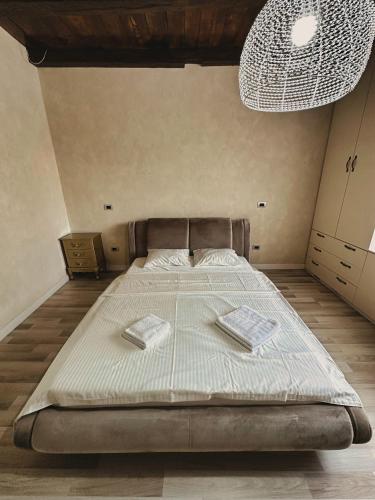 a bedroom with a large bed with two towels on it at NEO's Ark - retreat in Giarmata