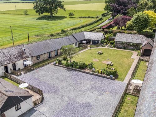 an aerial view of a house with a large yard at The Old Stables in Blandford Forum