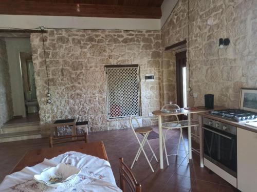 a kitchen with a table and a kitchen with a stove at Casa Rurale Pietra Bianca in Roccamorice