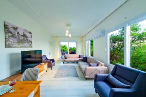 a living room with couches and a table at Umut villa in Göcek