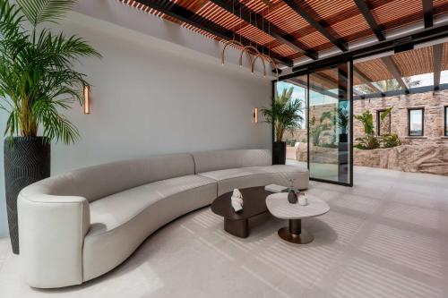 a living room with a white couch and a table at Noir Mykonos in Mýkonos City