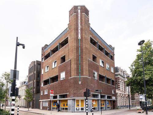 a tall brick building on a city street at City Center Stay Fast Wi-fi, Designer Bathroom in Tilburg