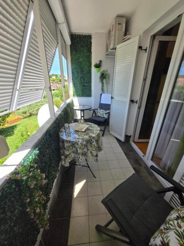 a balcony with a table and chairs in a room at Jasna - apartman studio in Pula