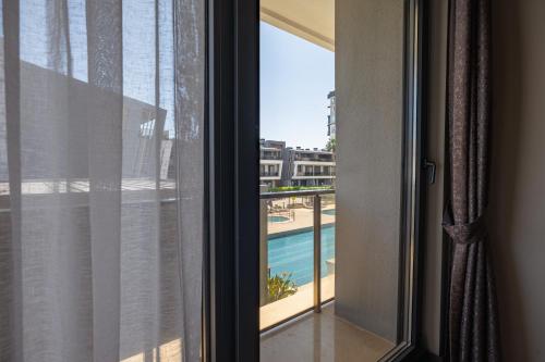 a room with a window with a view of a pool at Glory Life in Antalya