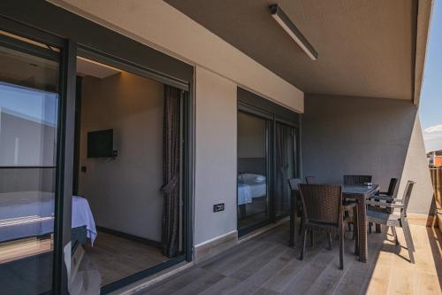 a room with a bed and a table and chairs at Glory Life in Antalya