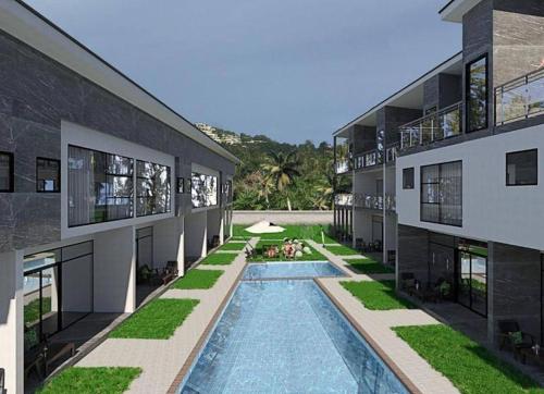 einen externen Blick auf ein Gebäude mit einem Pool in der Unterkunft Discover your sanctuary at this townhouse in Plai Laem